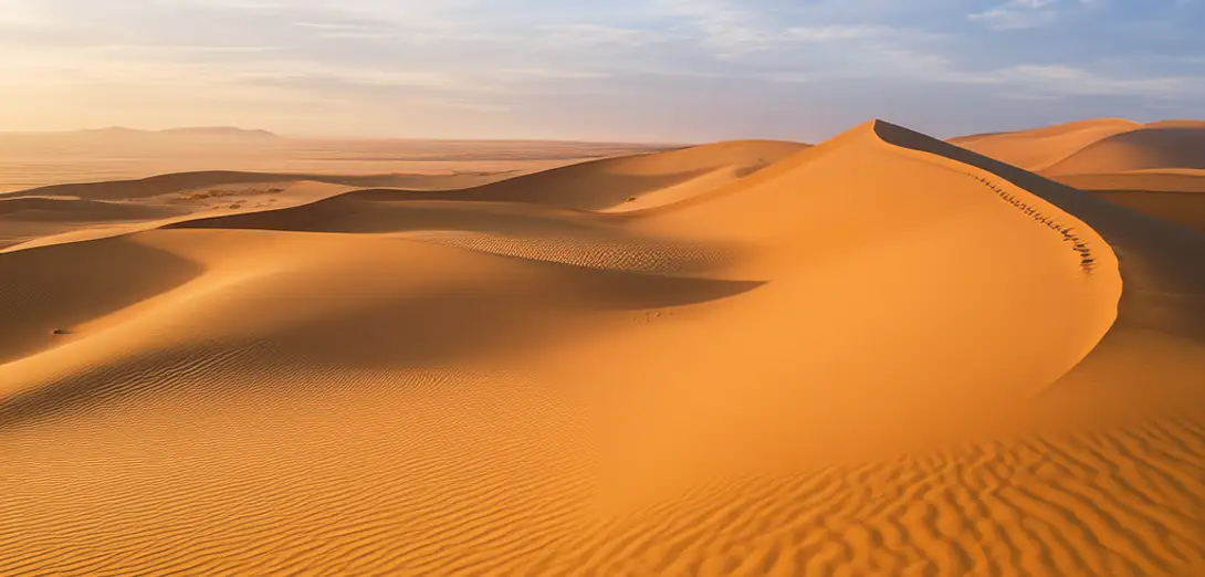 Why Desert Sand Dunes Align in Parallel Ridges